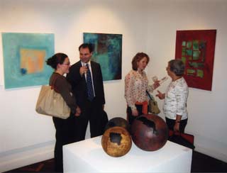 Visitors in front of paintings by Eva Ryn Johannissen